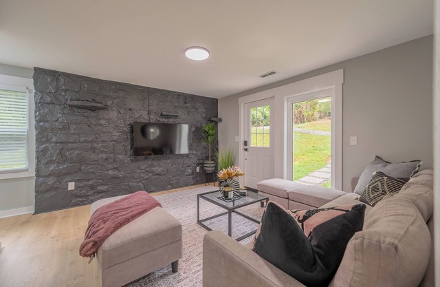 Charming entry and spacious back deck surrounded by nature, perfect for a peaceful getaway.
