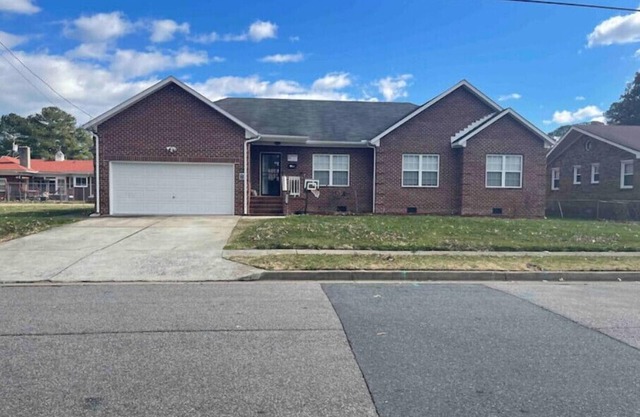 Cheerful 4-BR Brick ranch home with a fireplacen