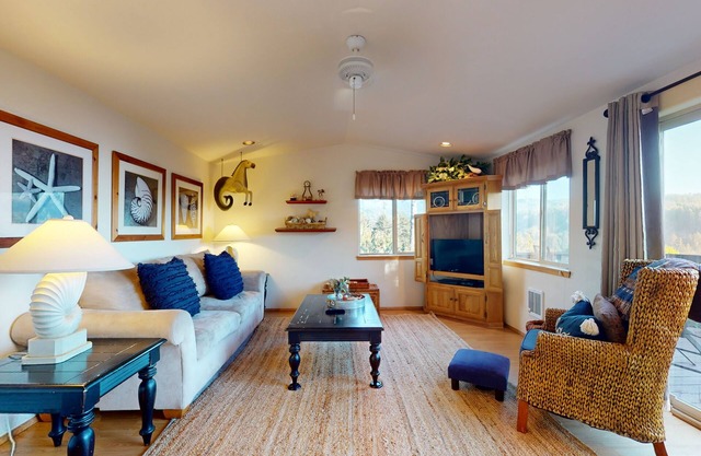 Coastal retreat steps from the beach with a private hot tub & nautical theme