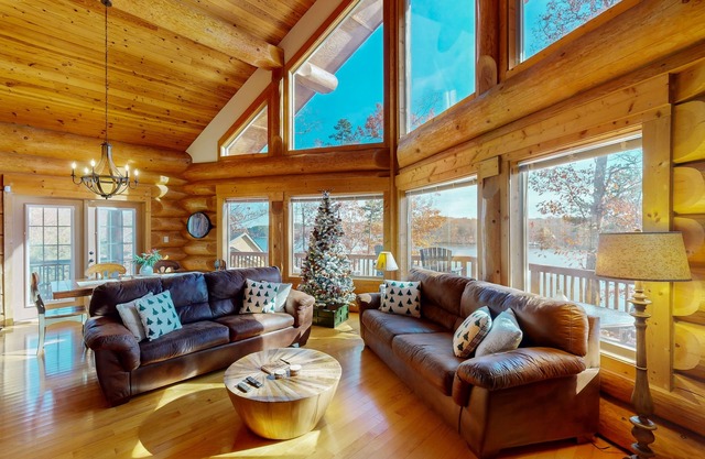 Custom lakefront home with lake views, hot tub, firepit, fireplace, dock, & deck