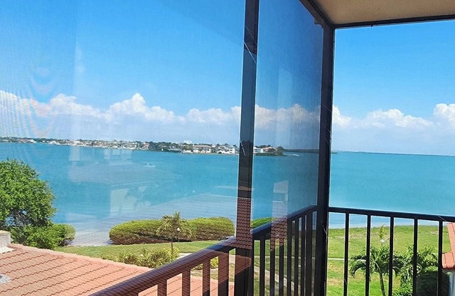 Enjoy spectacular sunrises and water views from this 4th floor condo in Isla!