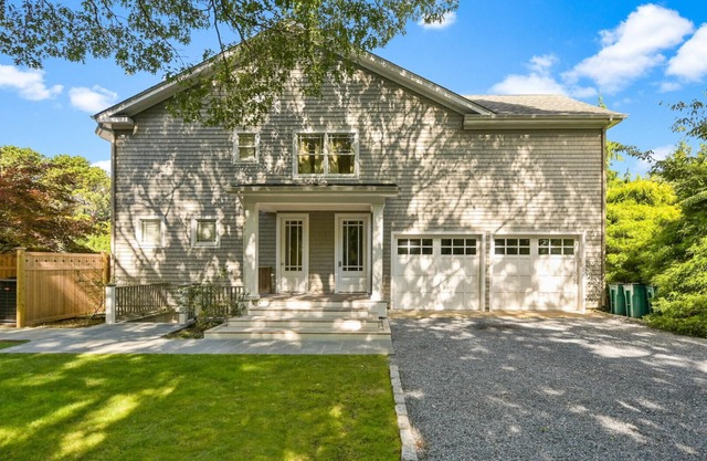Exceptional shingle-style home sited on just under an acre of land,.