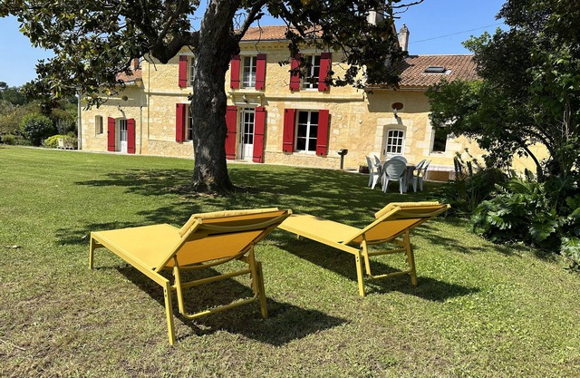 Family house on a Bordeaux winery, overlooking a garden with century old trees