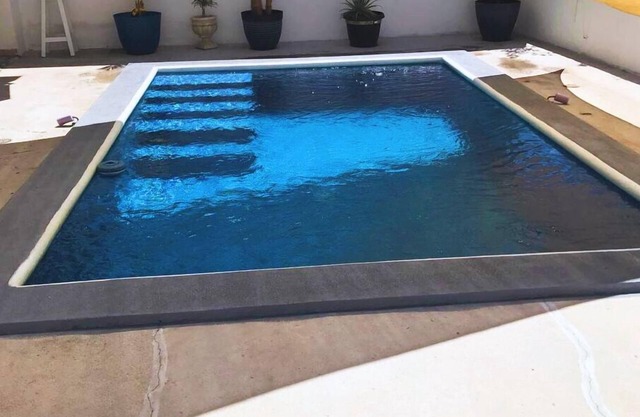 Family home with private pool one block from the beach