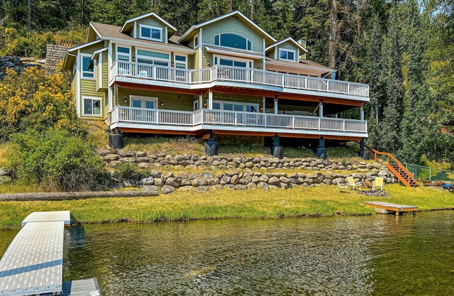 Grand waterfront home w/decks offering lake views plus boat slip & nearby dock