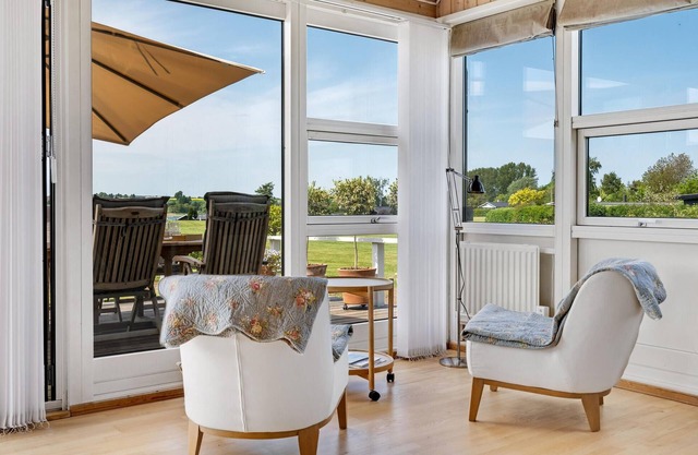 Highly furnished wooden house with wood-burning stove, fjord view and boat dock.