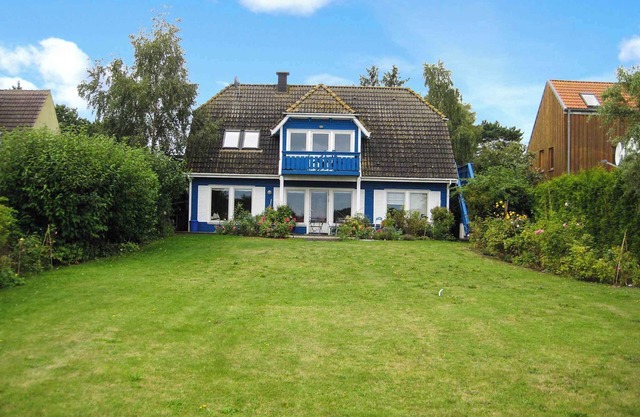 Holiday apartment with balcony, water view and garden