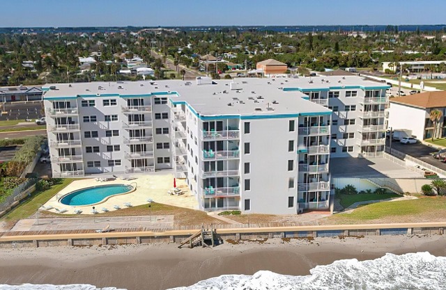 Inviting condo with ocean view, balcony, full kitchen, central AC, & W/D