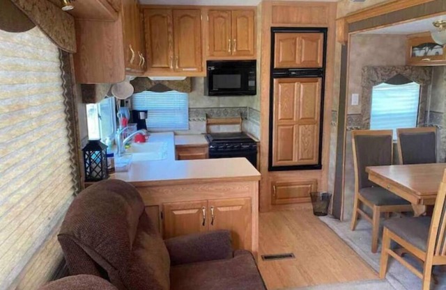 Lake shore queen bed trailer, tiki torches, & tent space for extra guest