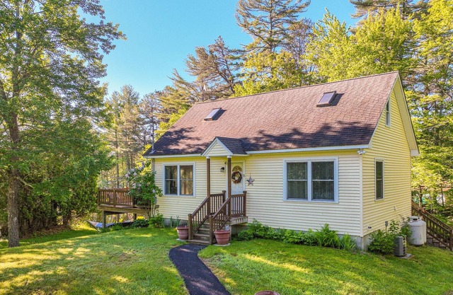 Lakefront home on Sheldrake Cove with dock & firepit