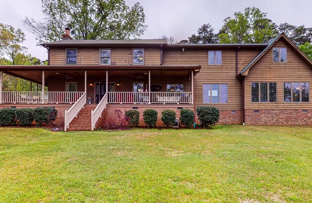 Large lakefront home with porch, private dock, fire pit, WiFi, & AC