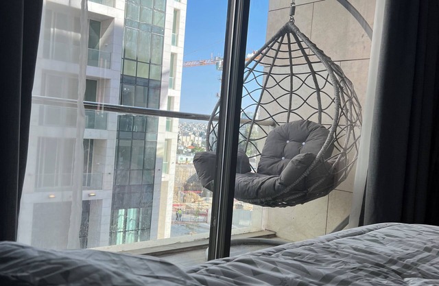 Live in the heart of Amman with this luxury one-bedroom suite featuring two balc