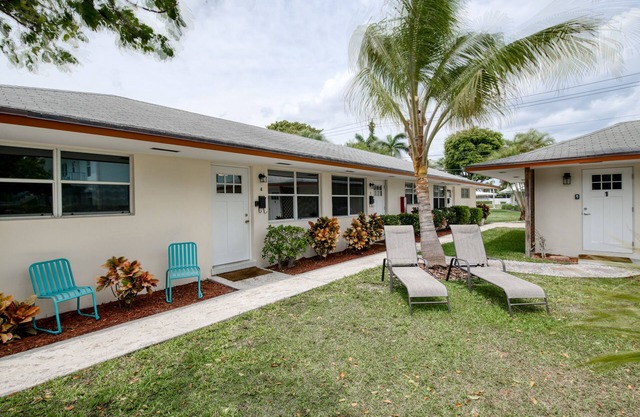 Modern condo near towering palms with beach decor, grill, & yard - walk to beach
