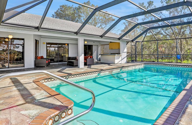 Modern home with enclosed private pool on 7th tee of Oak Hills Golf Club