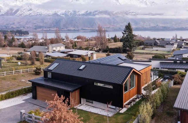 Modern house with lake and mountain views