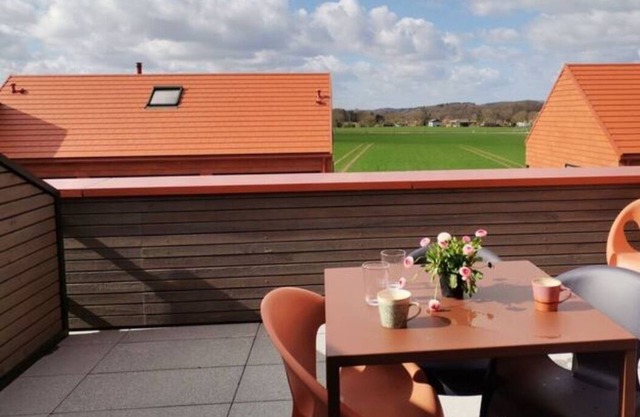 Modern two-story apartment with rooftop terrace.