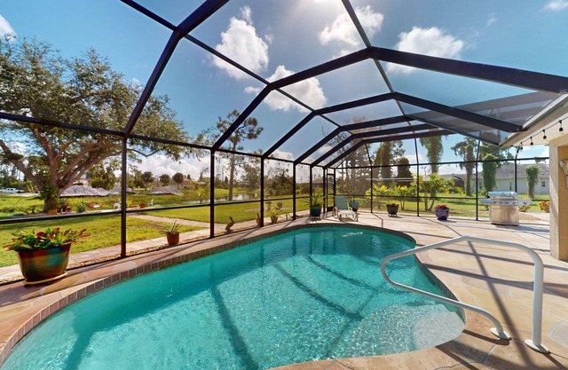 Nautical charmer on the canal with heated pool, sunny lanai, grill, W/D, and AC