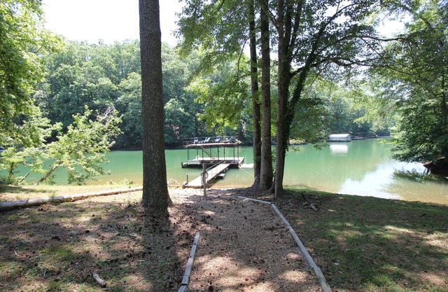 Quiet lake cove home with single slip dock