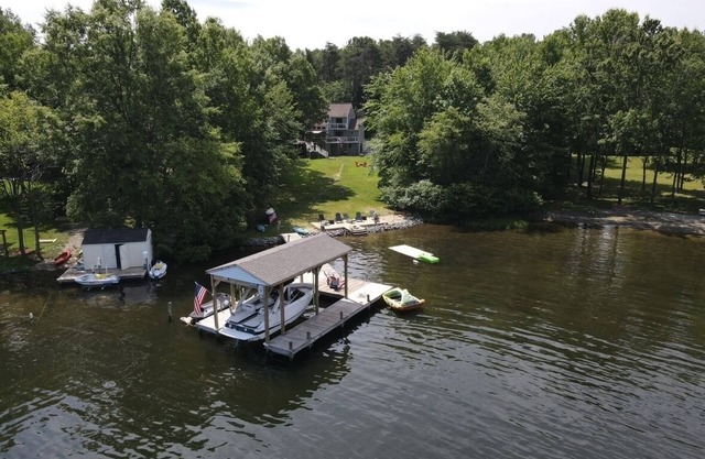 Spacious lakeside home featuring a private cove, hot tub, dock & theater room
