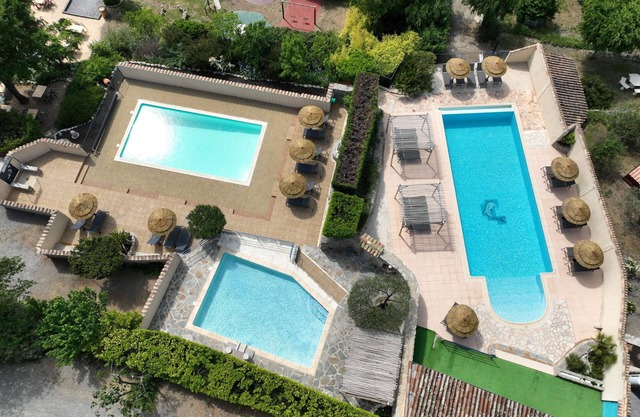 Stone cottage, fireplace, swimming pools, playground, enclosed park with trees