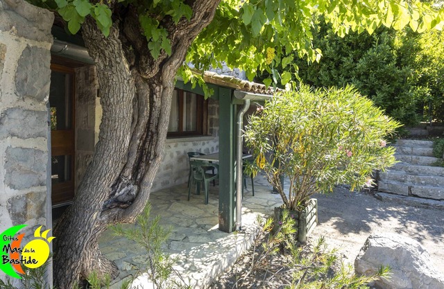 Stone cottage, swimming pools, playground, enclosed gite village with trees