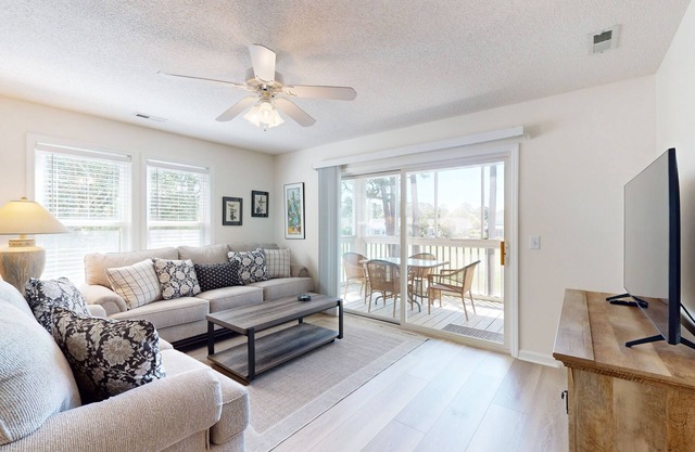 Sunny condo with pool, tennis, balcony, washer/dryer, smart TVs, & central AC