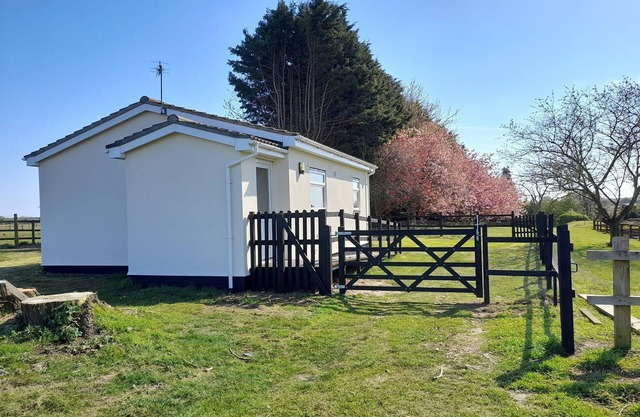 The Paddocks - a bungalow situated in a rural village surrounded by fields and horses