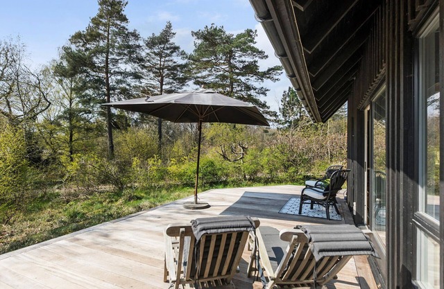 This attractive wooden house welcomes you in a wooded residential area of Tisvildeleje.