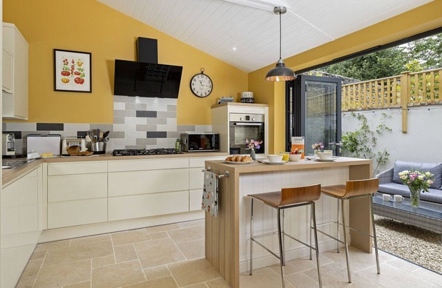 This charming Cotswold stone cottage, elegantly furnished with a seamless blend of antique and conte