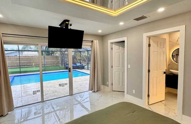 Tropical Luxury Retreat with warm Pool, 5-bedroom & Mini Golf, Impact Windows