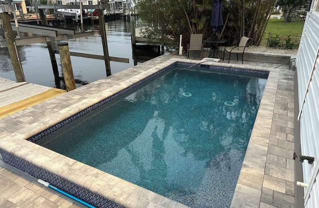Tropical Oasis Pool Kayak Bikes fish from dock