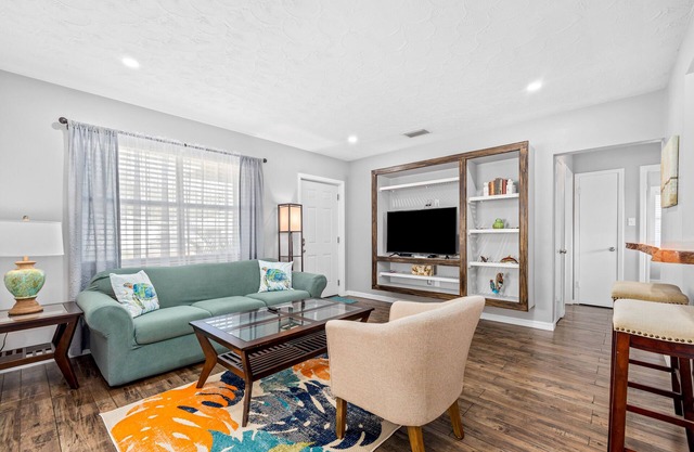 Updated, dog-friendly home with fenced yard, koi pond, firepit, & W/D