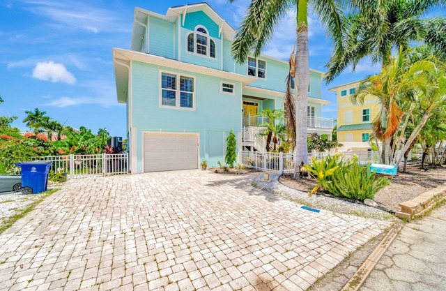 Waterfront home with private pool, dock, patio, balconies, & bikes