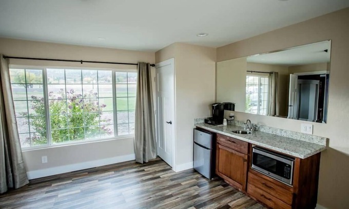 Medford Apartment | 1 bedroom with a king-size bed, one bathroom, and kitchenette.