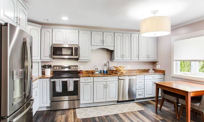 Edgewater House | 2-story, riverfront home with private dock, inviting deck & dog-friendly yard