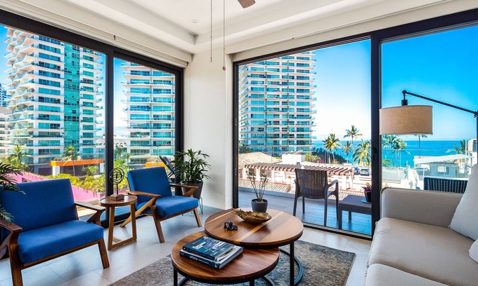 North Hotel Zone Condo | 5th-floor condo with partial ocean views, heated pool, sauna, gym, balcony, W/D