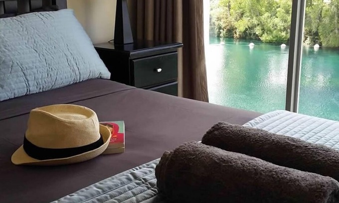 Taupo Apartment | Absolute waterfront apartment. Stunning river views. Swimming pool and kayaks.