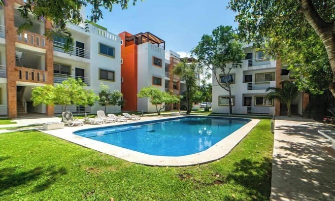 Alfredo V. Bonfil Apartment | Airport condo w/KING BED pool, security, kids game park + bbq area with lounge!