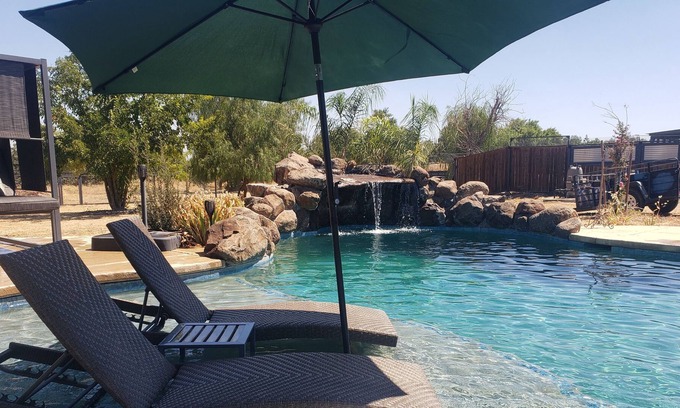 Woodland House | Althea House features a pool, firepit, grilling station, and friendly goats!