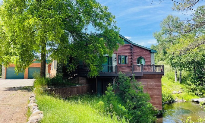 Grayling House | Ausable River waterfront 4-bed house in Grayling w/dock, patio, firepit, garage.