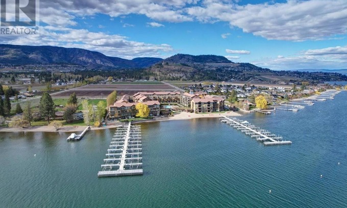 Central Okanagan Condo | Beachside Bliss! Spacious Ground Level Walk Out Patio Direct on the Beach & Lake