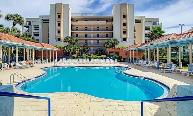 New Smyrna Beach Condo | Build family memories at this 3BR condo in New Smyrna Beach, just steps across the street from the sand. Enjoy a pool & spa outside your door, a luxe master bath, spacious bedrooms, and resort-style amenities in a gated community.