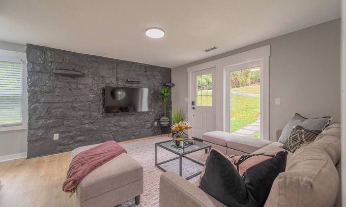 Blacksburg House | Charming entry and spacious back deck surrounded by nature, perfect for a peaceful getaway.
