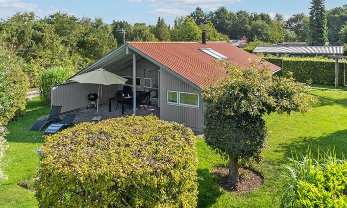 Nysted House | Chic cottage with large partially covered terrace.