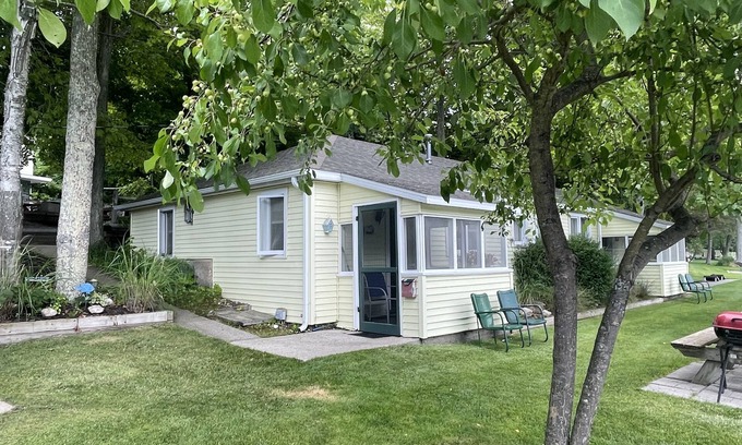 Ludington Cottage | Cottage 3 is a charming 2 bedroom 25’ from your boat dock & Hamlin lake.