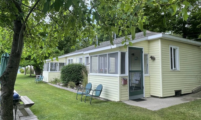 Ludington Cottage | Cottage 4 is a charming 2 bedroom 25’ from your boat dock & Hamlin lake