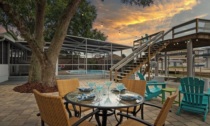 Butler Beach House | Cozy Canal Escape! Screen Covered Pool, Sunroom, Sun Deck, & Floating Boat Dock