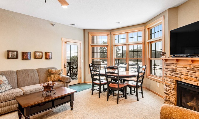 Three Lakes Condo | Cozy condo w/ lake-view, balcony, fireplace, pool, game room, & washer/dryer