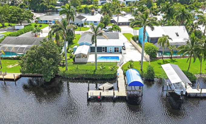 Palm City House | Deep water front home with private dock, pool, outdoor kitchen and pool table.