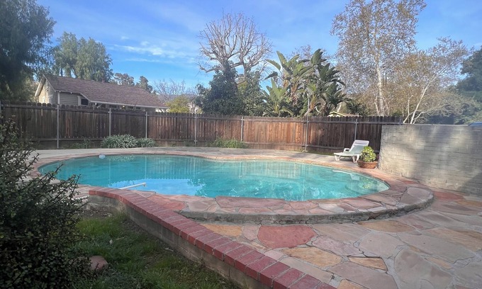 Sunland House | Dog friendly cottage with porch, pool, massive yard, and plenty of parking.